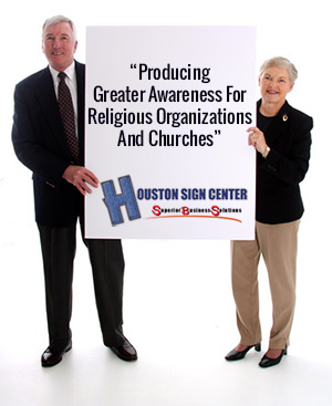 Senior couple holding a church sign